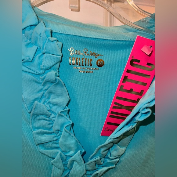 UPF 50 Luxletic Frida Ruffle Polo
Top in blue horizon Medium only worn once - Picture 2 of 3
